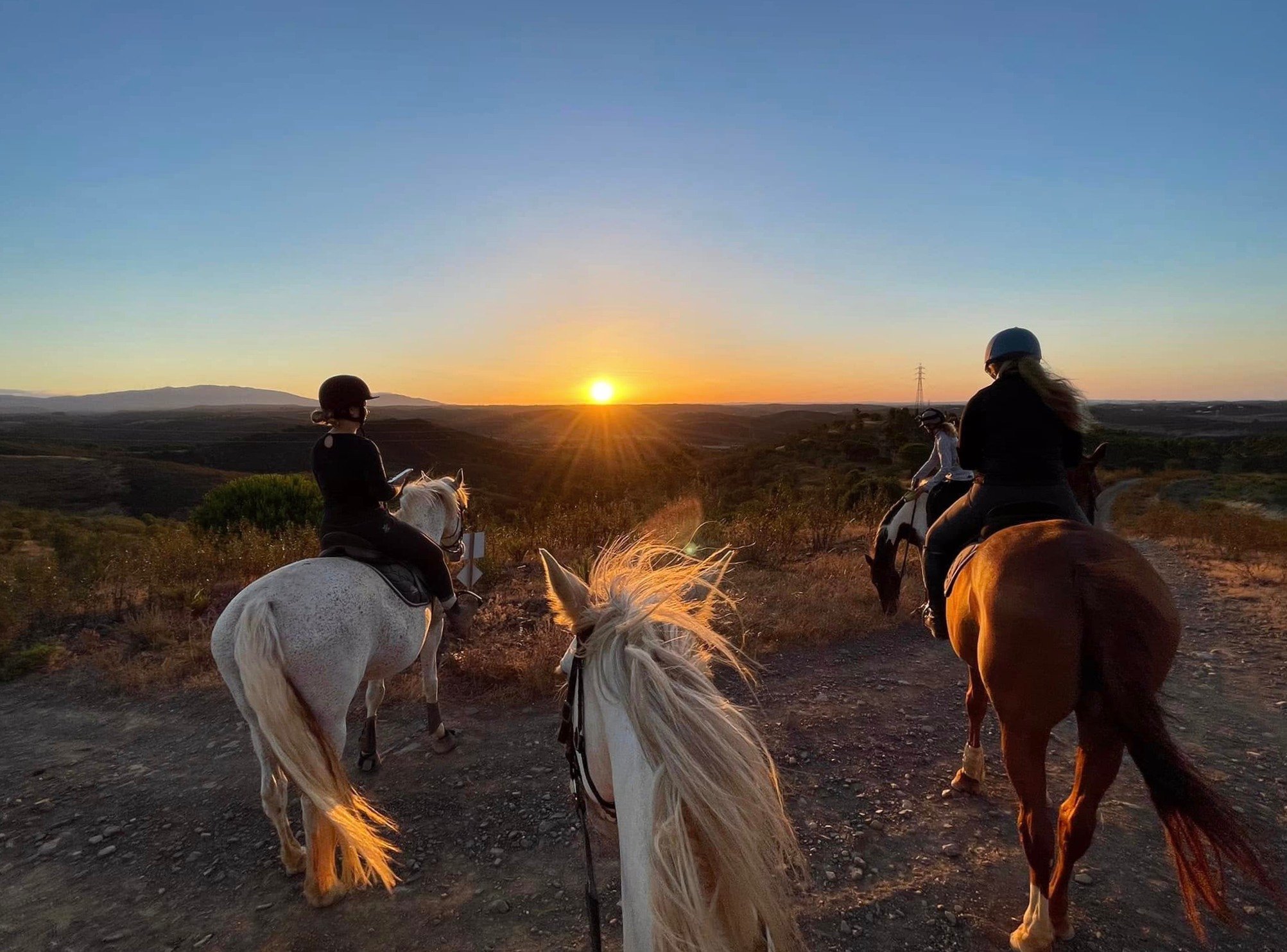 Riders on horseback through the Algarve countryside